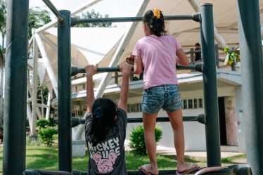 A couple of kids that are on a playground