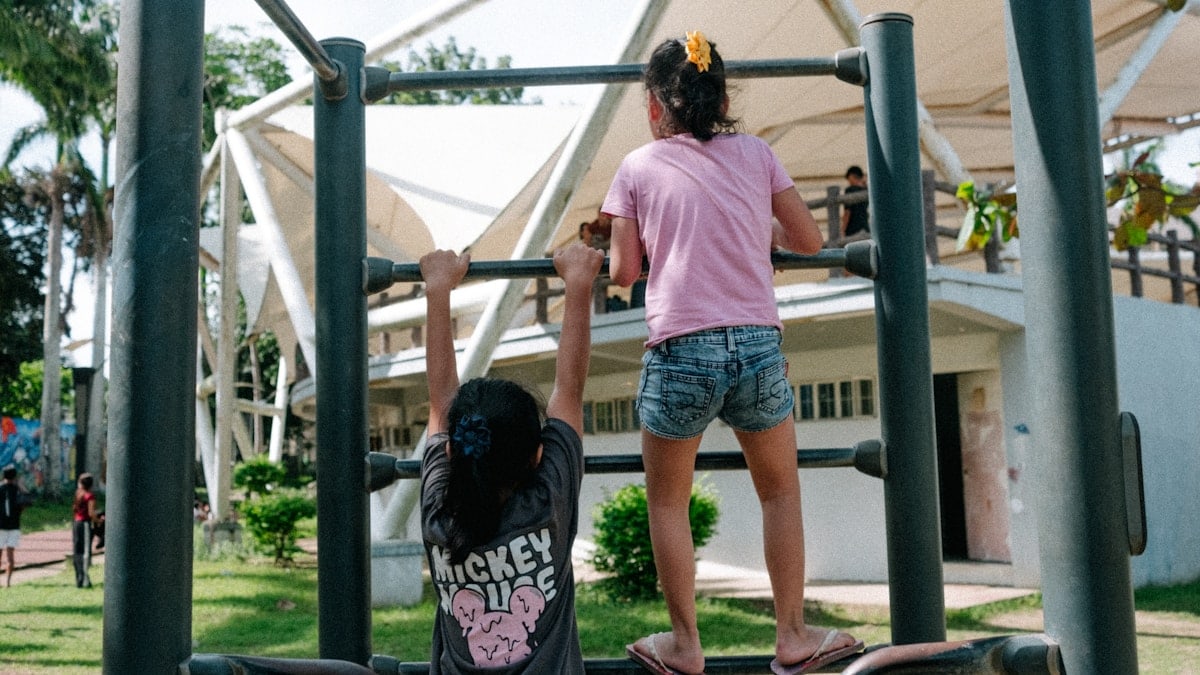 A couple of kids that are on a playground